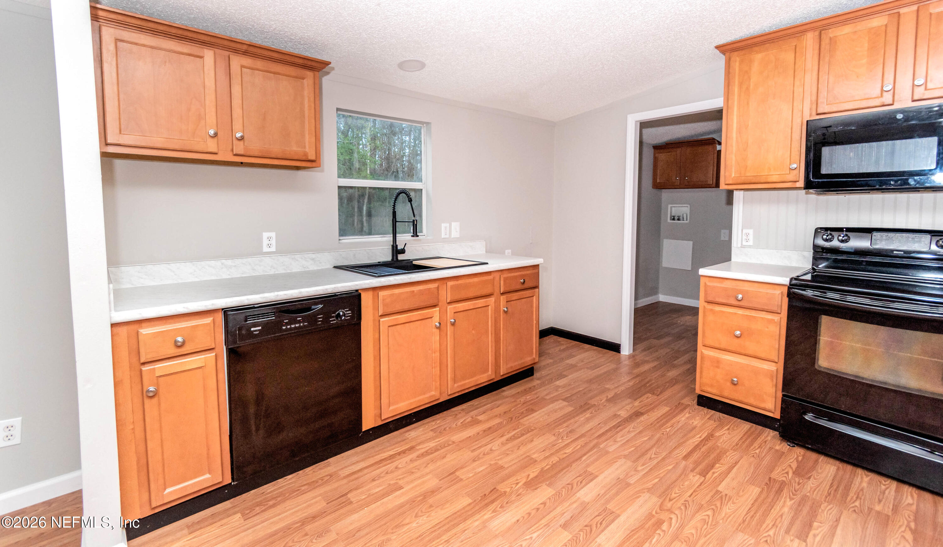 11017 County Road 229 Sanderson, FL 32087 - Photo 7 of 33 a kitchen with stainless steel appliances granite countertop a stove a sink and a microwave