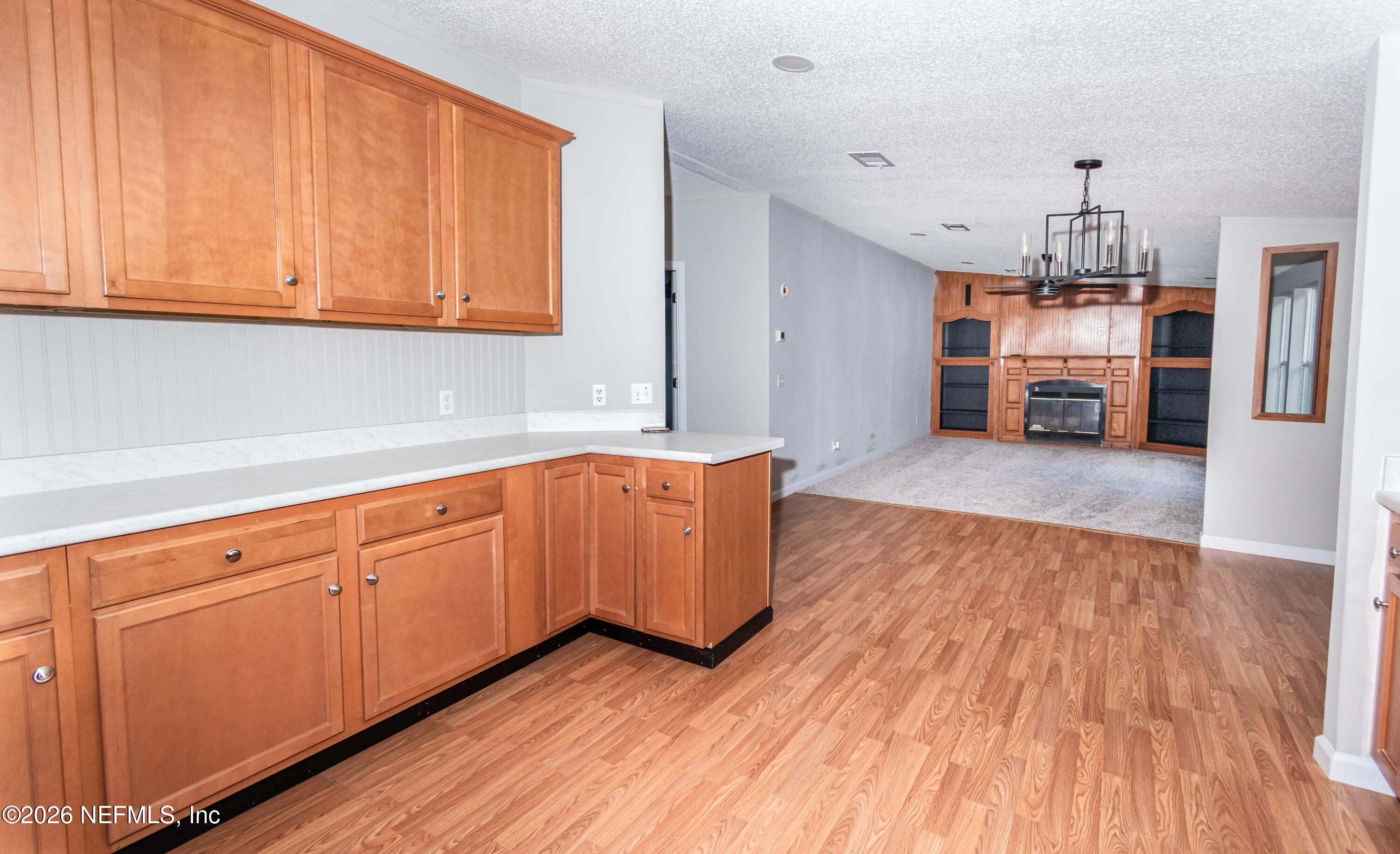 11017 County Road 229 Sanderson, FL 32087 - Photo 8 of 33 a kitchen with wooden floors and cabinets