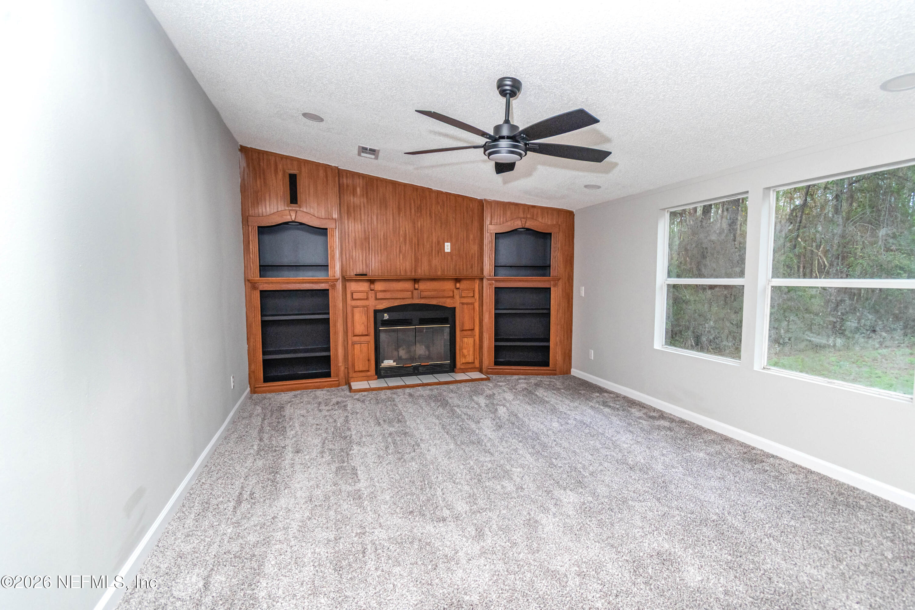 11017 County Road 229 Sanderson, FL 32087 - Photo 10 of 33 a view of empty room with a fireplace and window