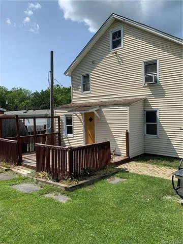 a view of a house with yard and sitting area
