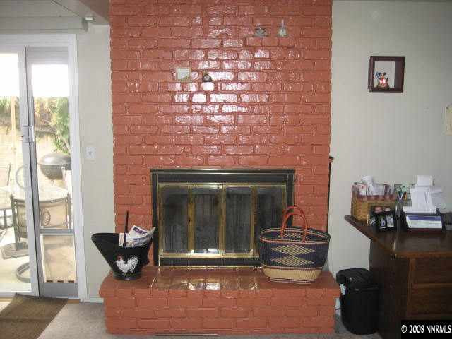 1975 Carlin Street Reno, NV 89503 - Photo 5 of 9 a living room with fireplace furniture and a floor to ceiling window