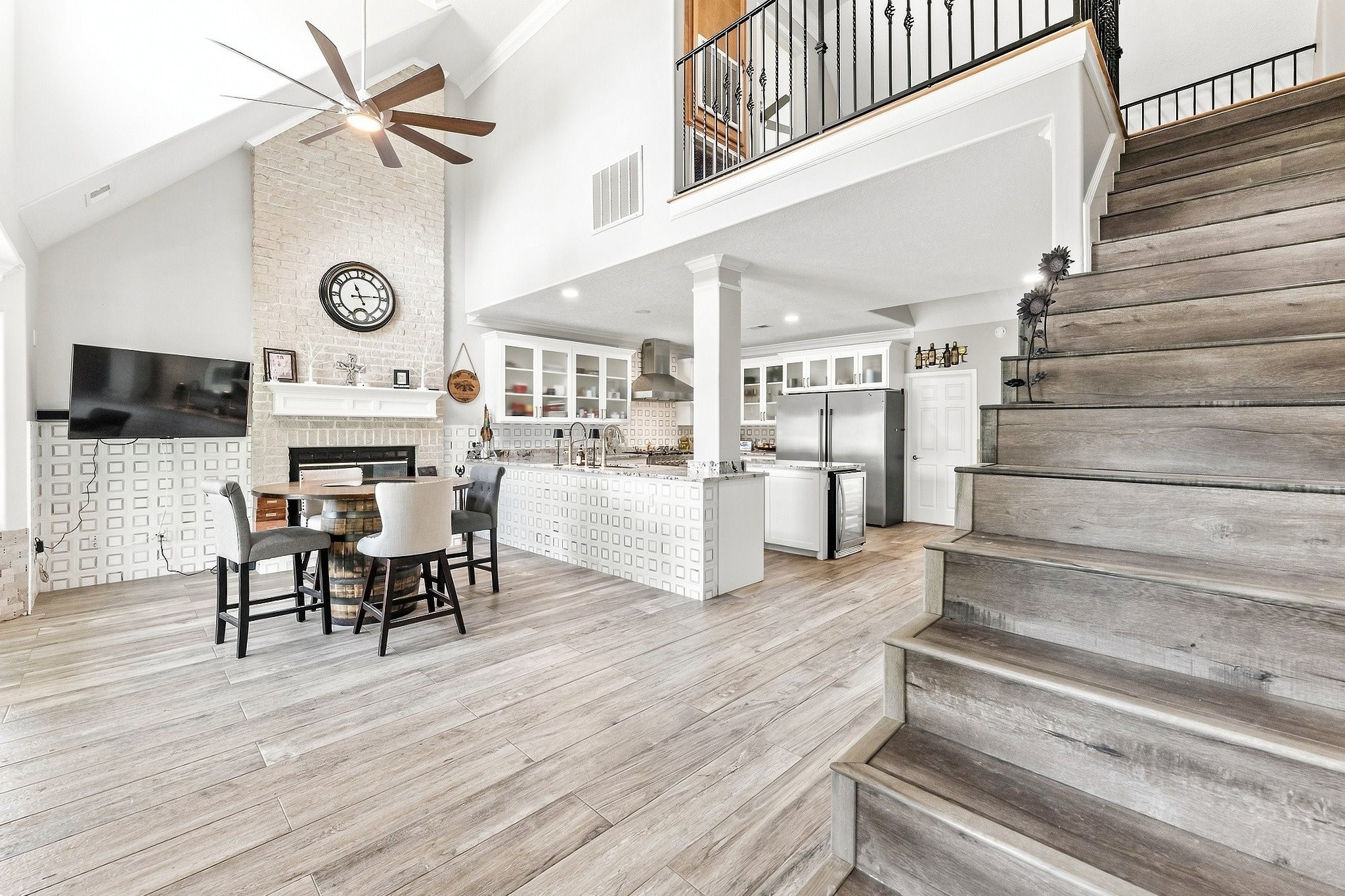 9010 Point Barrow Road Beach City, TX 77523 - Photo 26 of 50 The transition upstairs begins with a dramatic view over the main living area, where the open second-story overlook emphasizes the home’s vertical scale and connects the upper level back to the heart of the house.