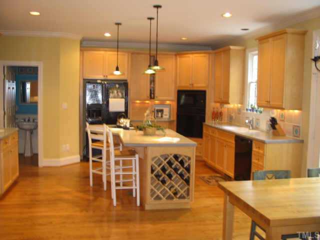 3124 Cranesbill Drive Raleigh, NC 27613 - Photo 2 of 12 Updated Kitchen w/ Black Appliances, Wet Bar, Secretary's Desk, Island, Solid Surface Countertops & More!