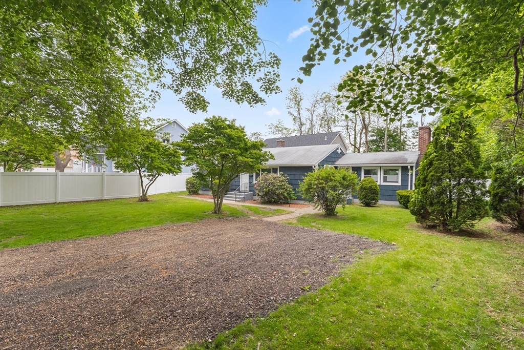 5 Phoenix Street Worcester, MA 01604 - Photo 6 of 32 a view of a house with a big yard and large trees