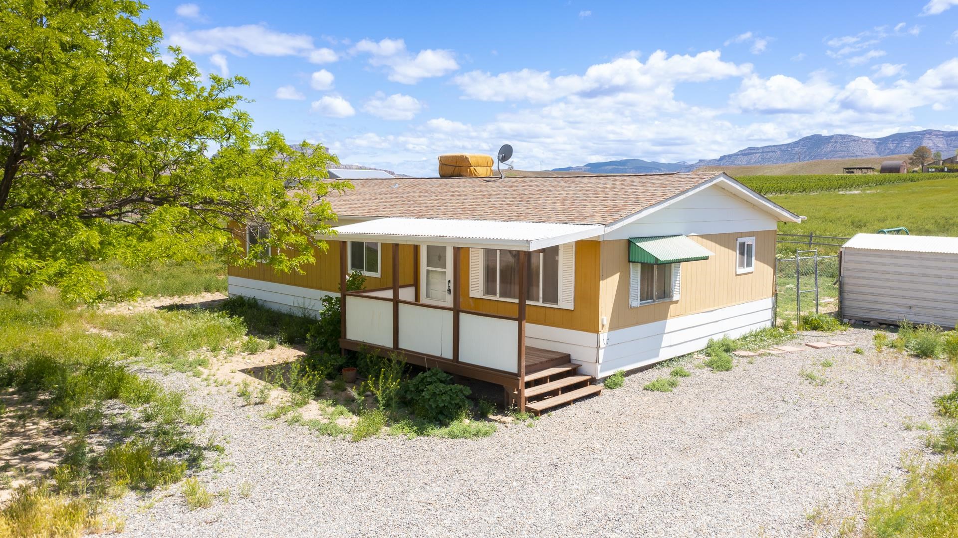 412 35 Road Palisade, CO 81526 - Photo 9 of 39 a front view of a house with a yard