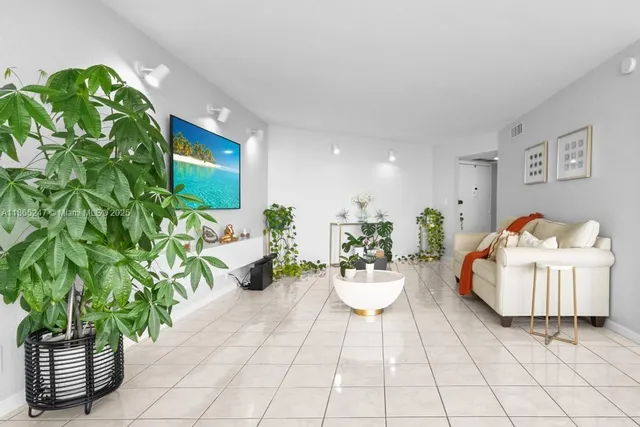 a living room with furniture and a potted plant