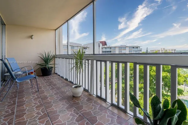 a view of a porch with furniture and floor to ceiling window