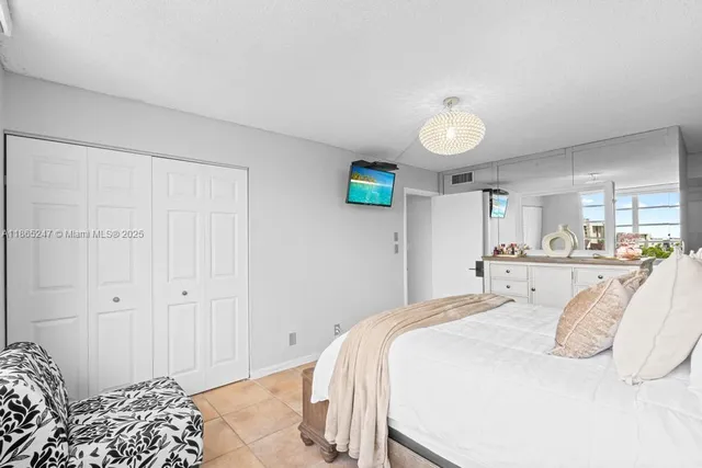 a bedroom with a bed and a lamp