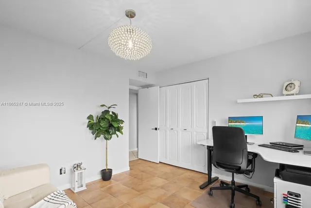 a view of a workspace with furniture and a potted plant