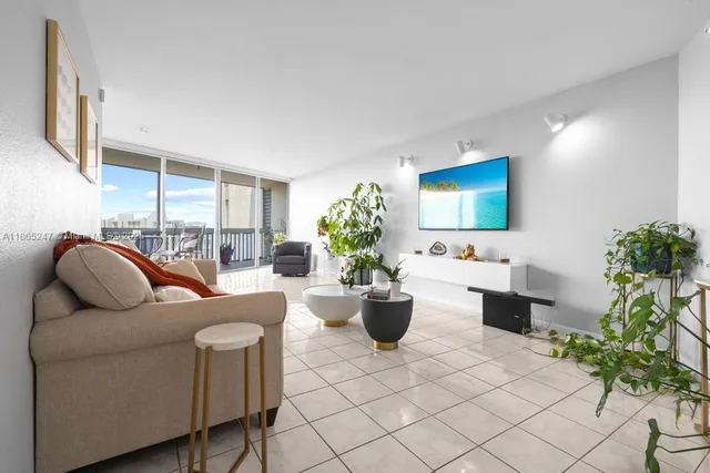 a living room with furniture potted plant and a window