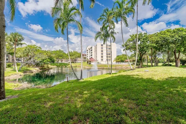 a view of swimming pool with a garden and trees