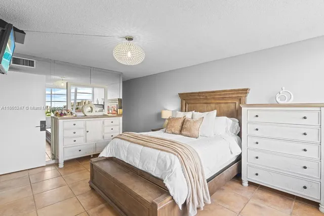 a large white bedroom with a bed and a window