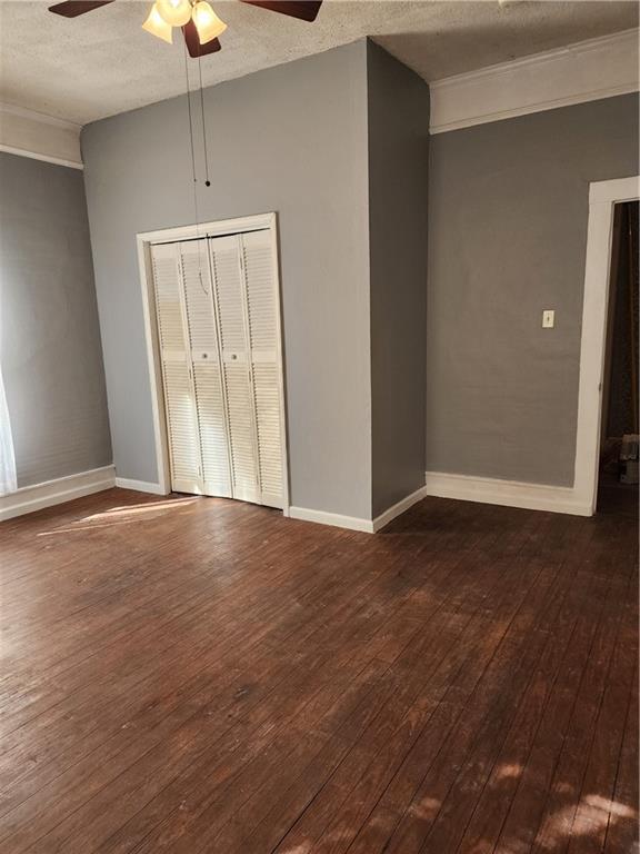 200 Cave Spring Street Southwest Rome, GA 30161 - Photo 14 of 16 an empty room with wooden floor and chandelier fan