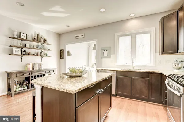 a kitchen with granite countertop cabinets sink and window