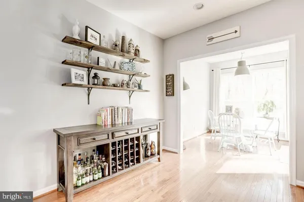 a room with furniture a chandelier and a wooden floor