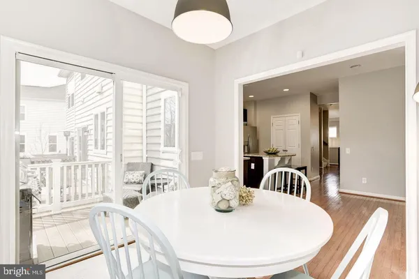 a view of a dining room with furniture a chandelier and wooden floor