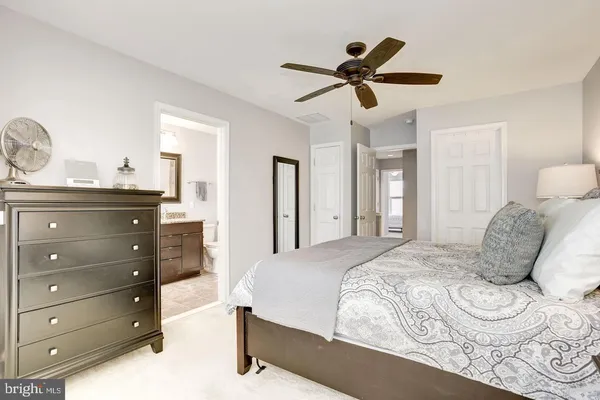 a bedroom with a bed and ceiling fan