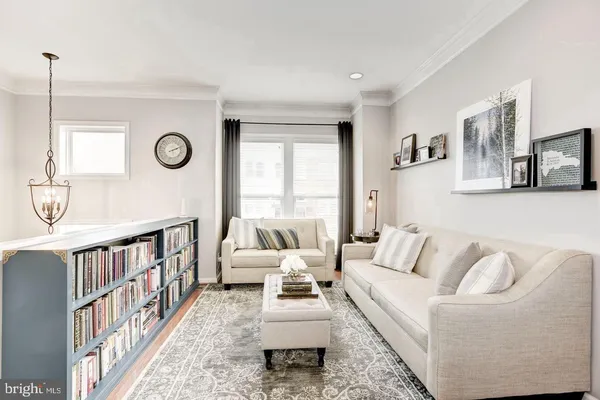 a living room with furniture a table and a window