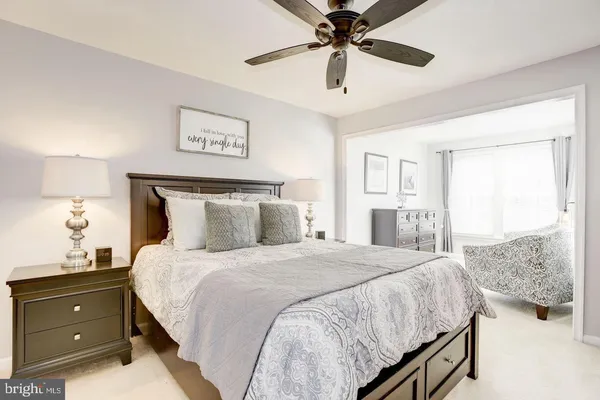 a bedroom with a bed and a mirror