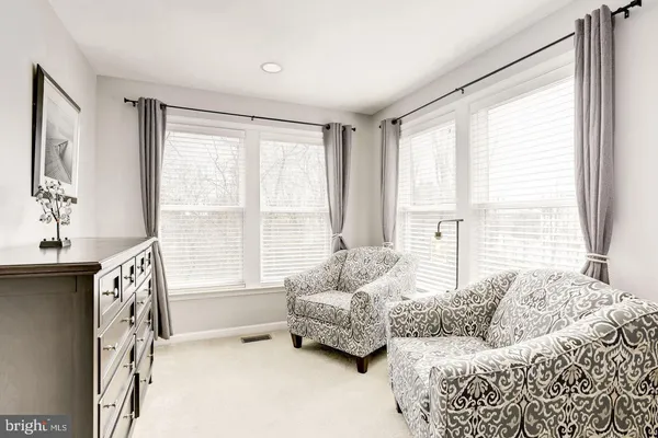 a bedroom with furniture and a large window