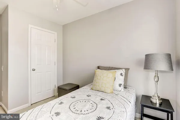 a bedroom with a bed and a lamp