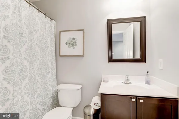 a bathroom with a toilet a sink and a mirror