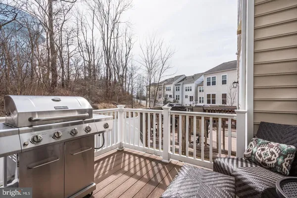 a view of a deck with couches and wooden floor