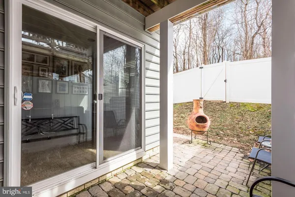 a bathroom with a glass door shower and a sink
