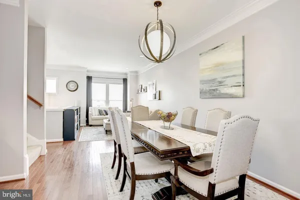 a view of a dining room with furniture and a chandelier
