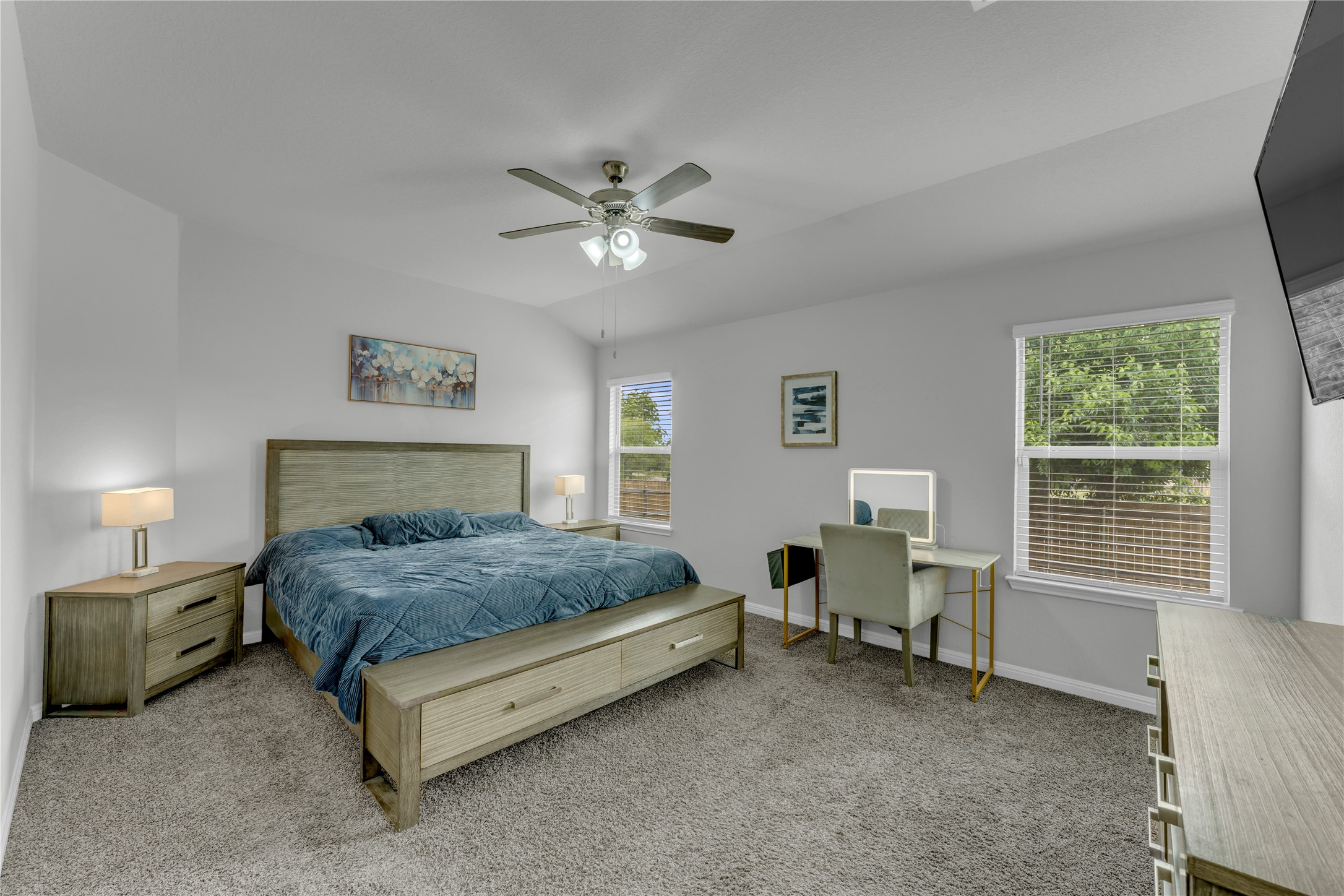 132 Cinnamon Loop Burnet, TX 78611 - Photo 11 of 27 Spacious bedroom featuring vaulted ceilings, neutral carpeting, and two windows providing natural illumination