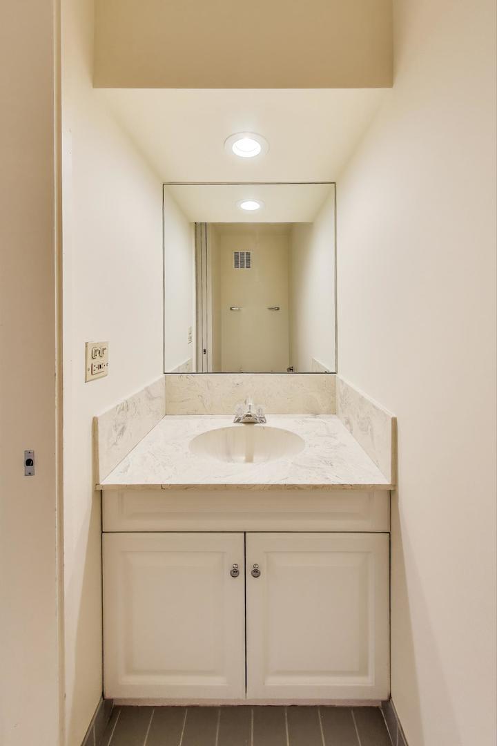 1630 Sheridan Road, Unit 2J Wilmette, IL 60091 - Photo 15 of 50 a bathroom with a sink and a mirror