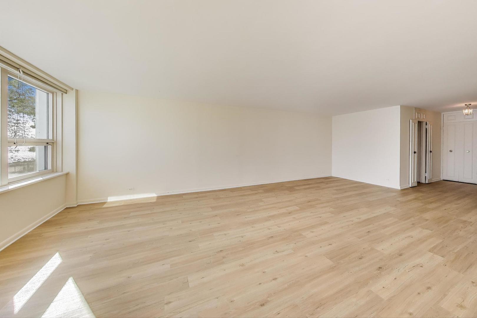 1630 Sheridan Road, Unit 2J Wilmette, IL 60091 - Photo 8 of 50 a view of empty room with wooden floor and fan