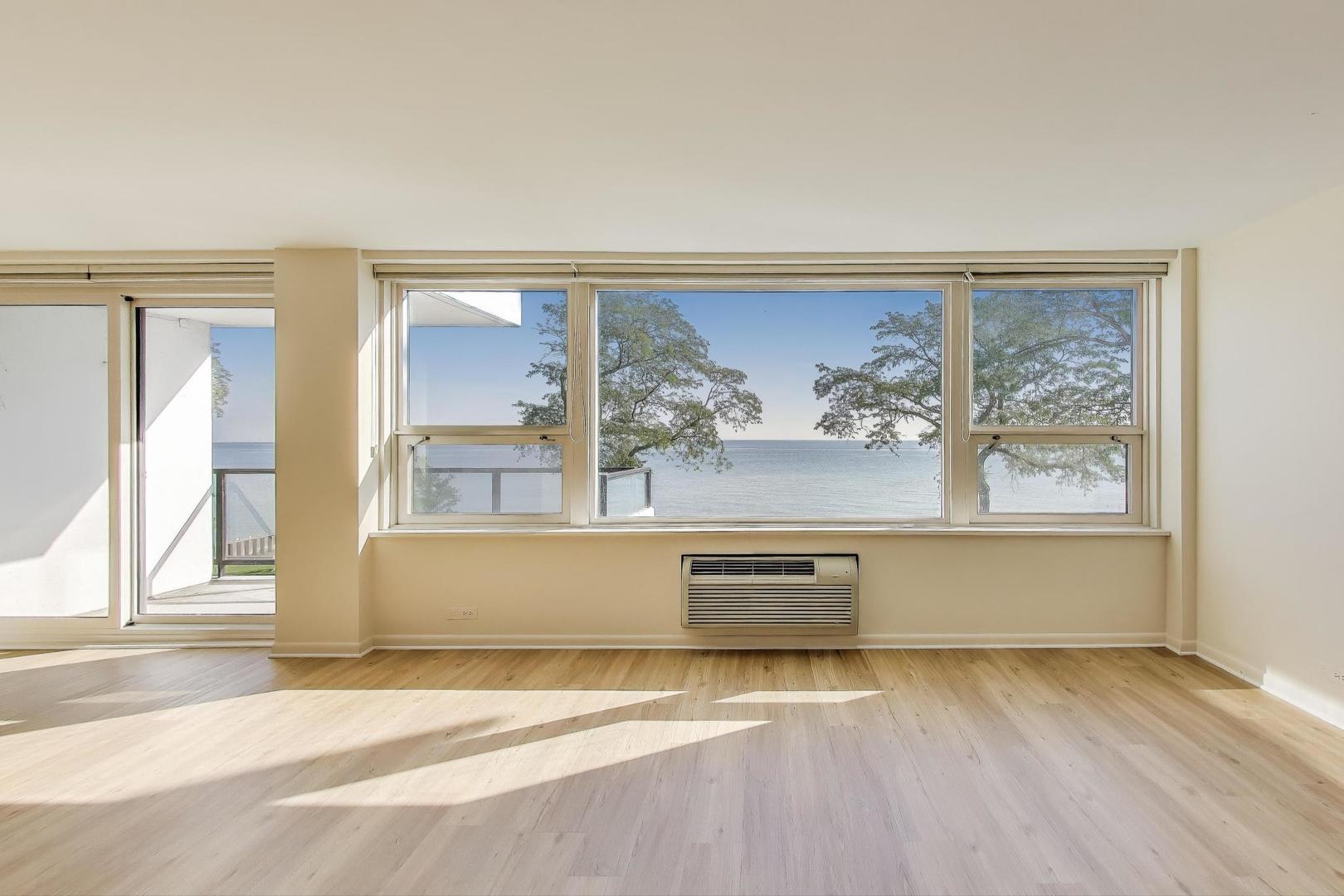 1630 Sheridan Road, Unit 2J Wilmette, IL 60091 - Photo 9 of 50 a view of a bedroom with wooden floor and a window
