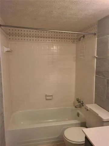 a bathroom with a shower and a toilet