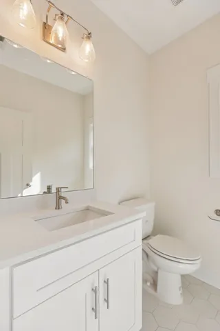 a bathroom with a sink a toilet and a mirror