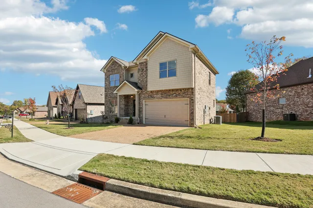 a front view of a house with a yard