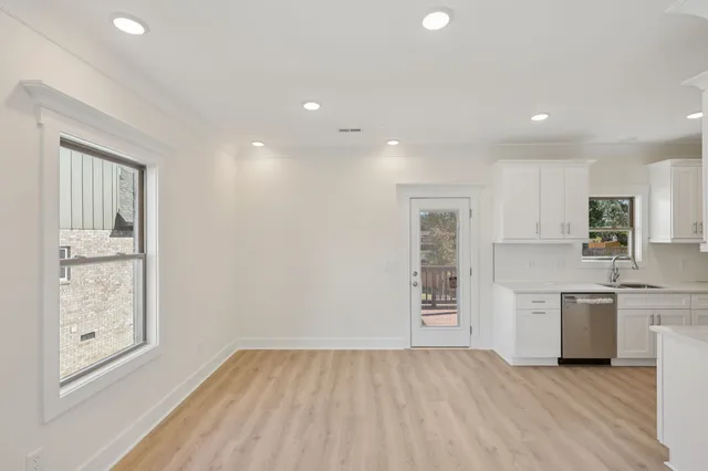 an empty room with closet and windows