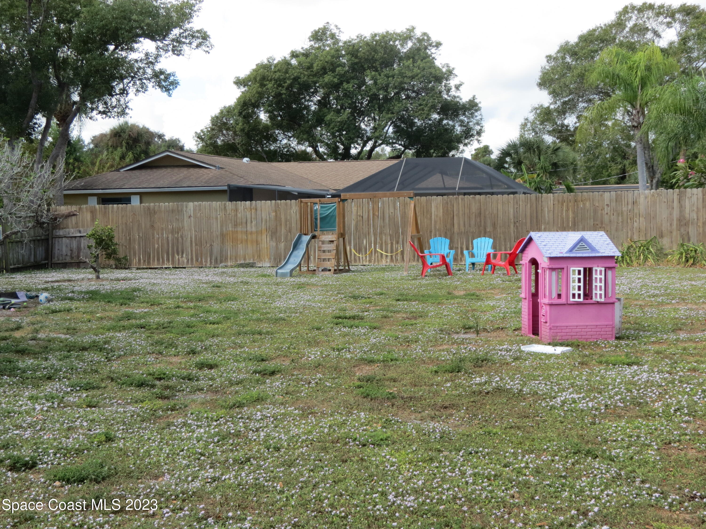 308 Arcadia Avenue Melbourne, FL 32901 - Photo 2 of 4 a view of backyard with wooden fence and trees
