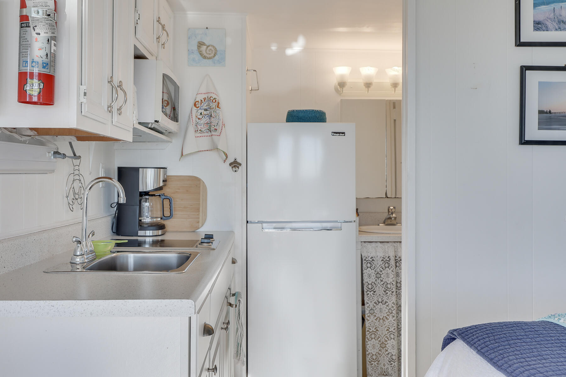 169 Shore Road, Unit 14 Truro, MA 02666 - Photo 13 of 40 a kitchen with stainless steel appliances granite countertop a refrigerator and a sink