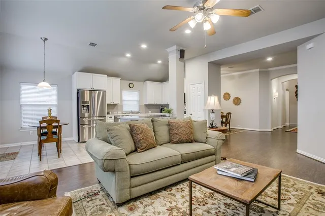 a kitchen with granite countertop a refrigerator stove top oven and sink