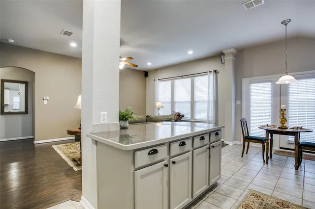 a kitchen with refrigerator cabinets and wooden floor