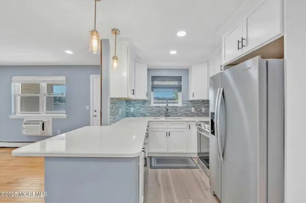 a kitchen with stainless steel appliances a refrigerator sink and microwave