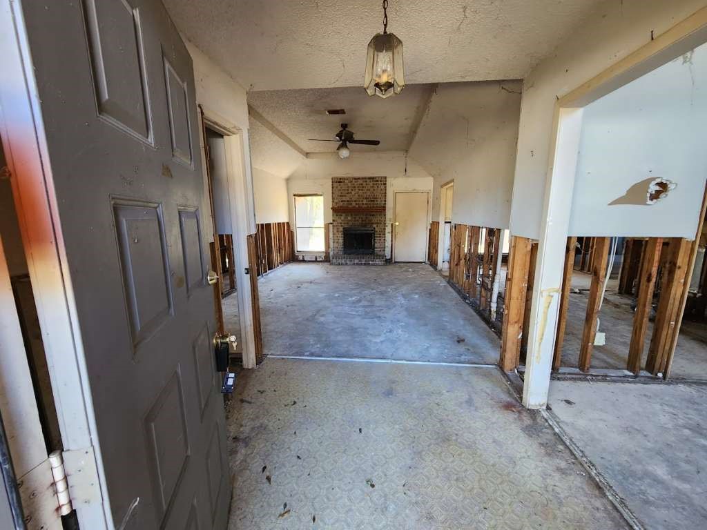 4401 Kitty Chapin Avenue Orange, TX 77632 - Photo 2 of 10 wooden floor in an empty room with a fireplace