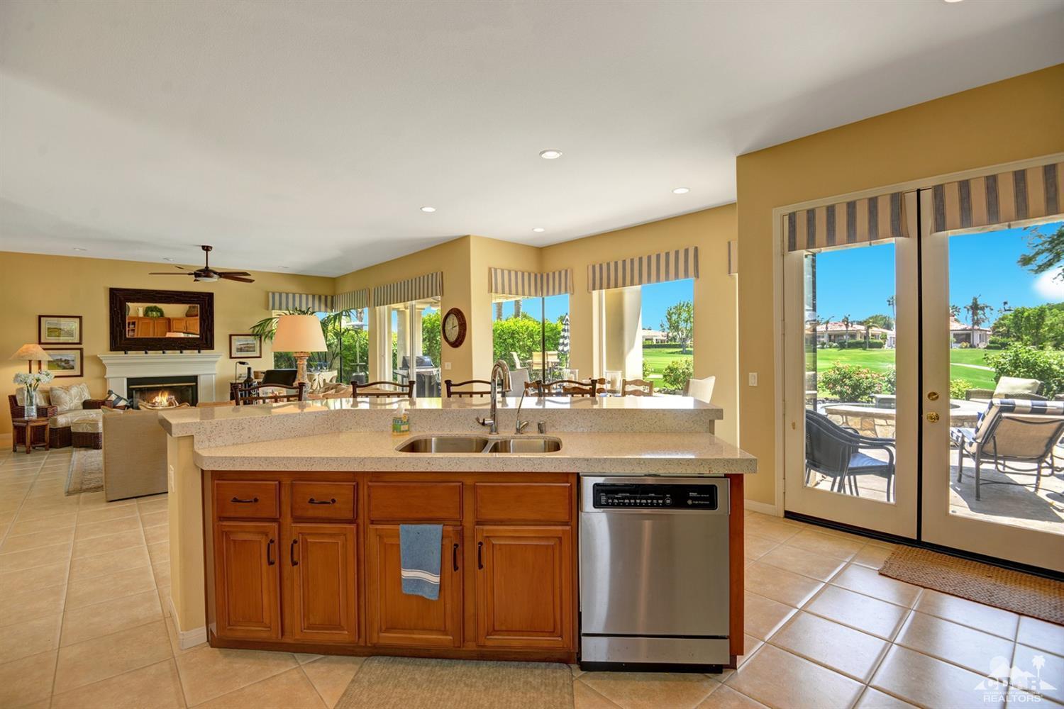 79675 Cetrino La Quinta, CA 92253 - Photo 18 of 34 a kitchen with stainless steel appliances granite countertop a sink and a counter top space