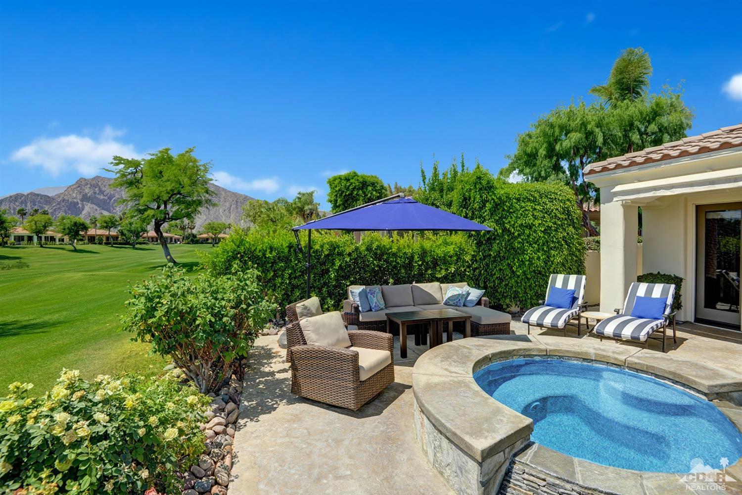 79675 Cetrino La Quinta, CA 92253 - Photo 3 of 34 a view of pool with lawn chairs under an umbrella