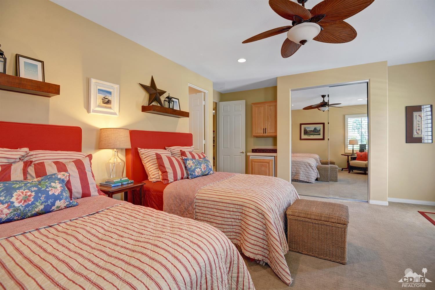 79675 Cetrino La Quinta, CA 92253 - Photo 22 of 34 a bedroom with two beds and a chandelier
