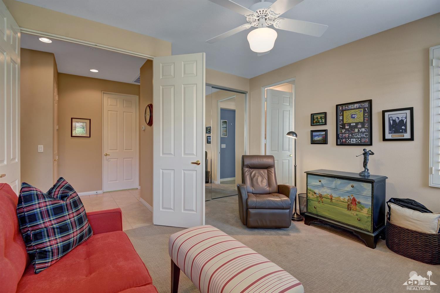 79675 Cetrino La Quinta, CA 92253 - Photo 25 of 34 a bedroom with furniture and a fireplace