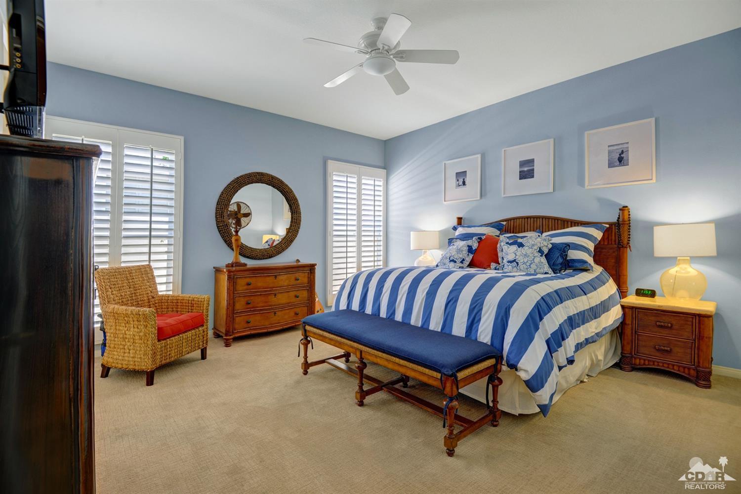 79675 Cetrino La Quinta, CA 92253 - Photo 28 of 34 a bedroom with a bed and a chandelier