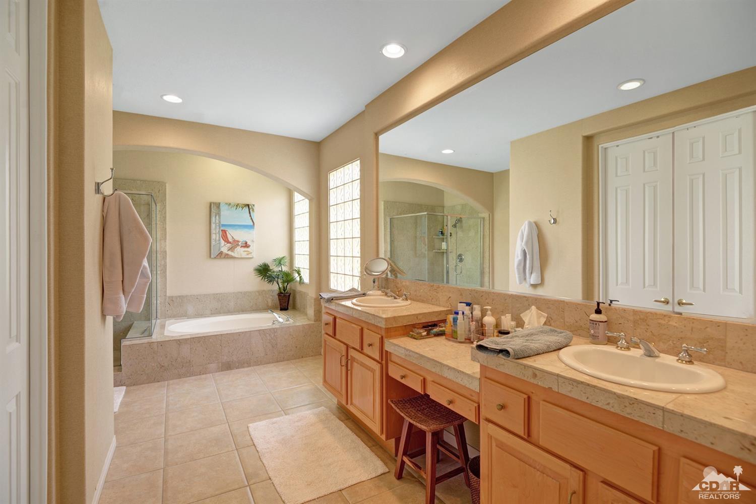 79675 Cetrino La Quinta, CA 92253 - Photo 30 of 34 a bath room with a sink double vanity granite tub shower and a mirror