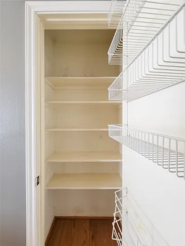 a view of staircase with white walls and a window